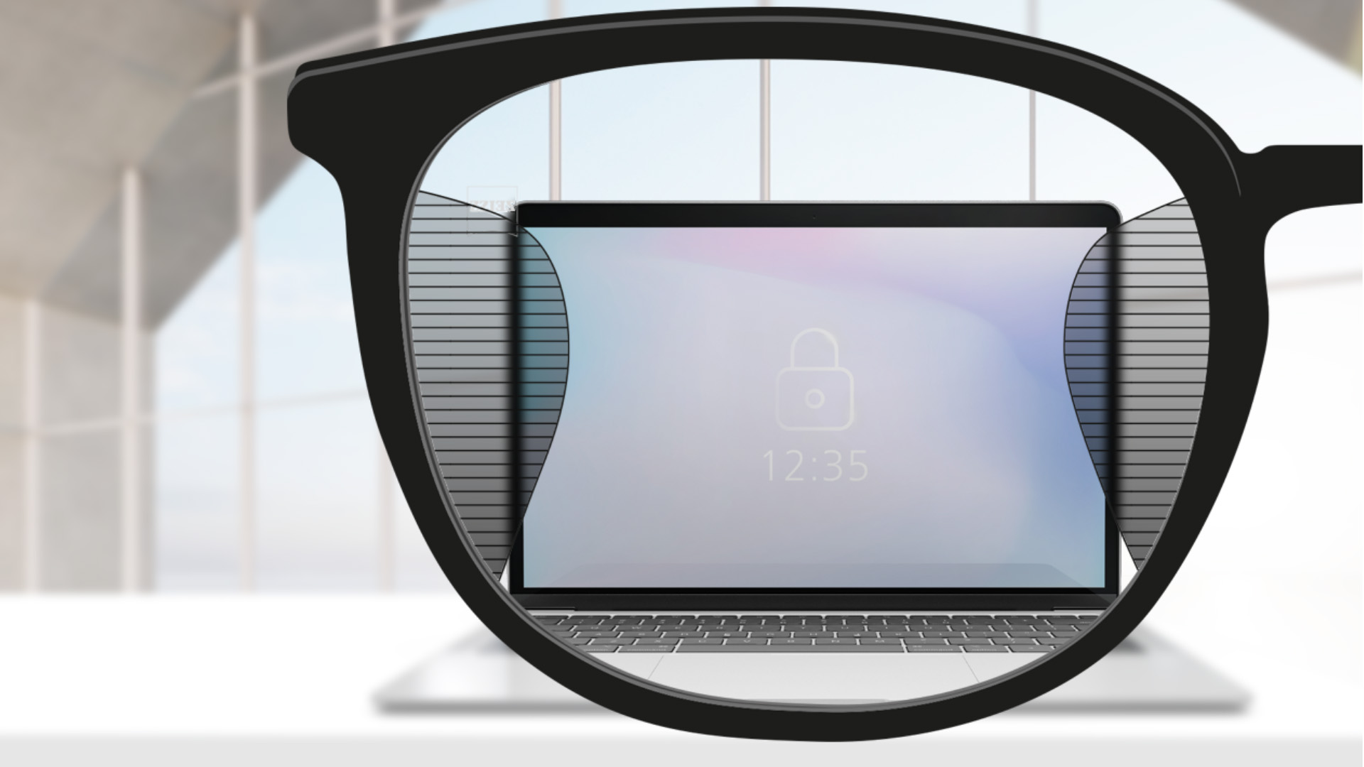 Obrázok zorného uhla so šošovkami ZEISS Office s obrazovkou počítača v strede šošovky a s tenkými rozmazanými políčkami vľavo a vpravo.